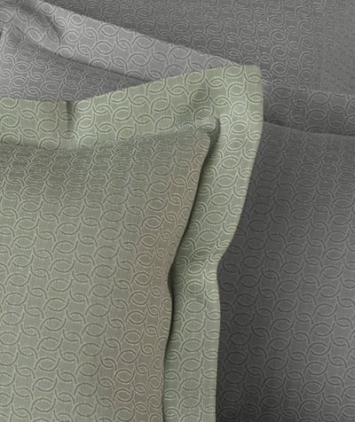 Celso de Lemos BIJOUX pillowcase: Close-up of green and grey patterned fabric with a flanged pillowcase in the foreground
